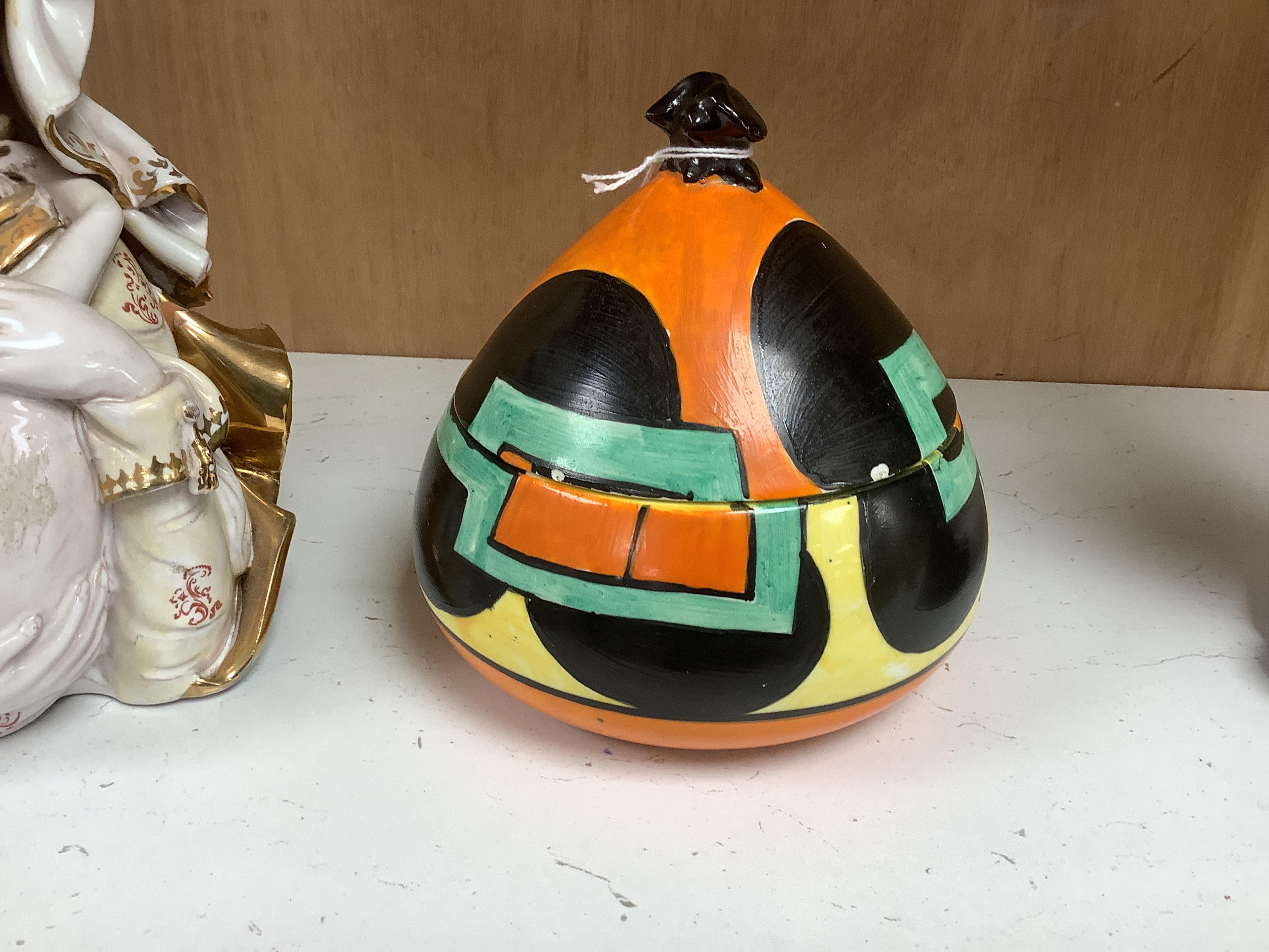 A Clarice Cliff Bizarre bon-bon jar and cover, 14cm. Condition - poor to fair, discoloured crazing to interior